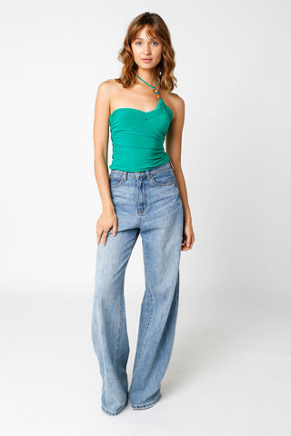 Cassia Green Halter Top styled with wide leg jeans and high heels
