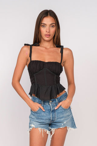 Elyse Black Peplum Top styled with distressed denim shorts