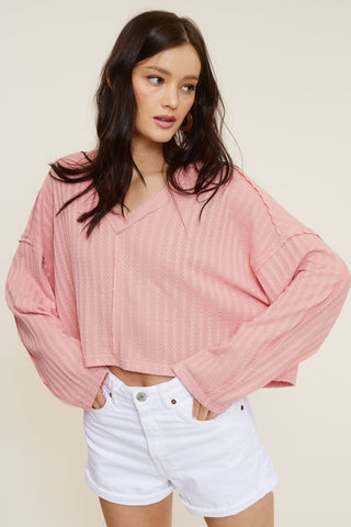 All The Way Pink Long Sleeve Crop Top showing drop shoulders and V-neckline