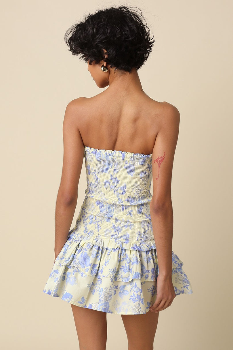 Back view showing the fit of the Aimee cream and blue floral strapless mini dress with smocked back detail