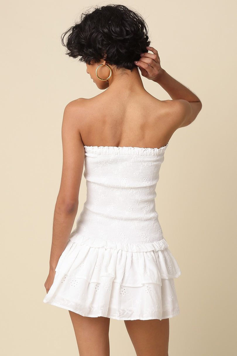 Back view of the Aimee white eyelet strapless dress showing the smocked bodice and tiered ruffle skirt