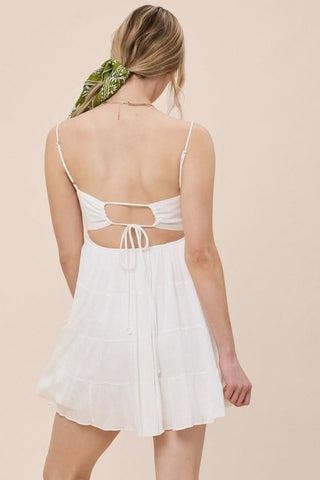 Feminine white tiered mini dress with adjustable straps - back view