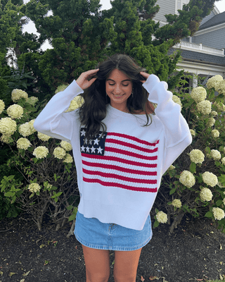 Girl Wearing American Flag Sweater in Outdoor Setting 
