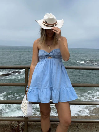 Chambray blue strapless romper dress styled for a coastal cowgirl look 