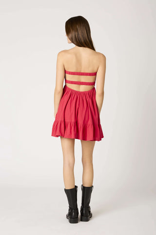 Back view of the red strapless babydoll romper dress showing the open elastic strap
