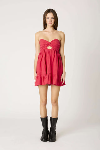 A vibrant cherry red strapless babydoll romper dress displayed on a studio model 
