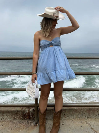 Argie white strapless romper dress paired with tall white western boots