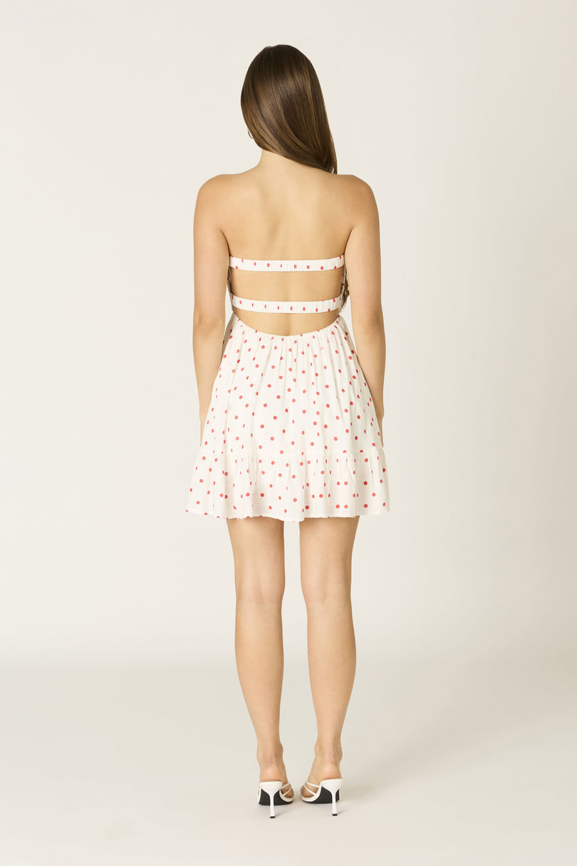 Detail view of the secure elastic bands on the back of the red and white polka dot Argie romper