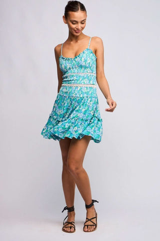 Model wearing the Ayla Teal Blue Floral Smocked Mini Dress styled with black lace-up sandals