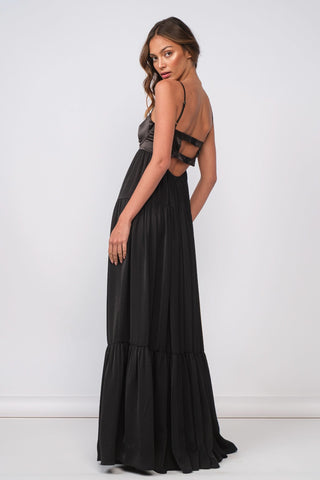 Back view of black satin maxi dress with elegant tiered skirt