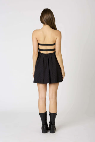 Back view of a strapless black babydoll dress with double elastic straps.