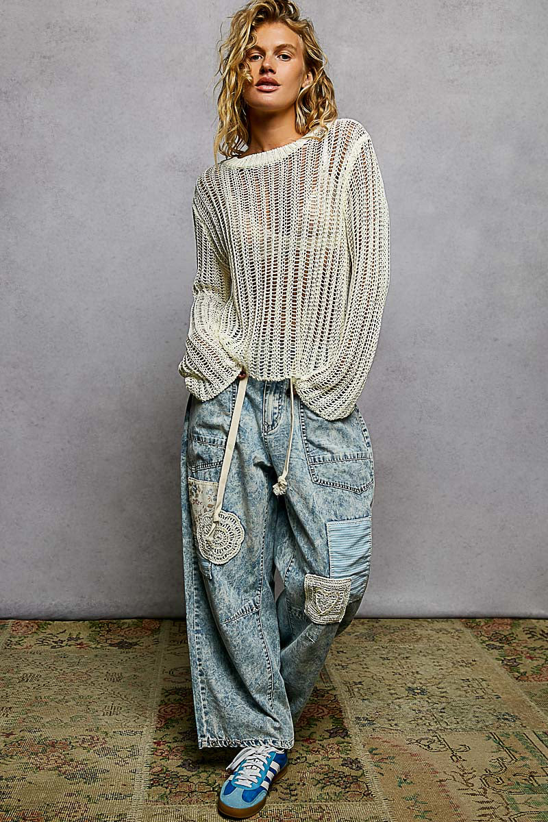 Full body view of the Sola white sheer sweater styled as a coastal beach outfit