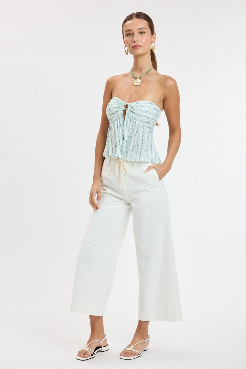 Lifestyle view of the blue floral coastal babydoll top showing the movement of the lightweight fabric