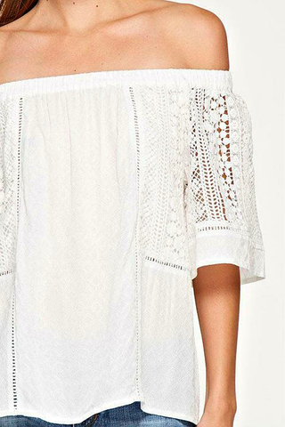 White off the shoulder top with crochet lace sleeve detail close up