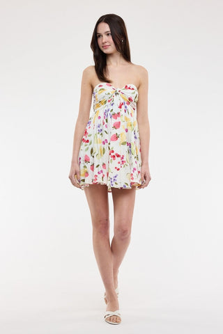 Model wearing the Colette fruit print dress, styled for a Euro summer vacation look
