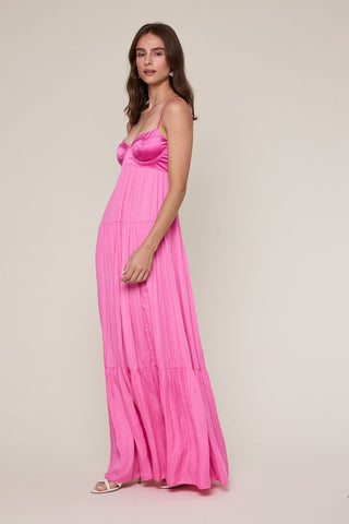 Side view of pink satin corset maxi dress with flowy skirt