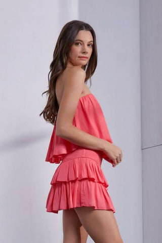 Coral strapless ruffle romper dress side view flowy silhouette