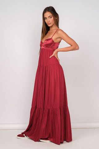 Side view of burgundy satin prom maxi dress with corset top