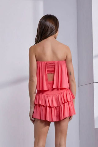 Coral strapless romper back view with tiered ruffle skirt