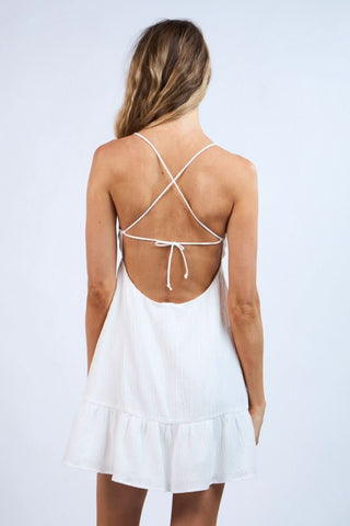 Back view of Demetra White Babydoll Cami Mini Dress showing backless criss-cross straps