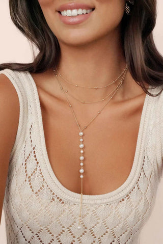 Model wearing the multi-strand Ettika pearl lariat necklace