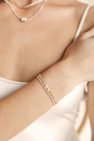 Ettika gold link bracelet stacked close-up