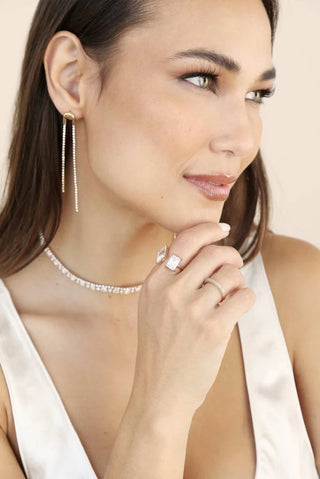 Ettika gold crystal double drop earrings on model