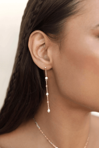 Ettika Double Piercing Freshwater Pearl Earrings worn with one piercing