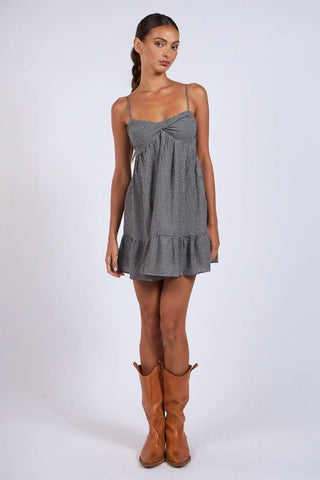 Full outfit view: Black gingham babydoll mini dress styled with cowgirl boots for a bohemian summer look | Boho Pink