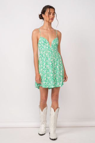 Woman wearing aqua green floral corset cami dress with cowgirl boots for summer concert