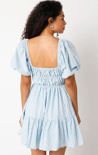 Back view of the Kendall blue eyelet dress featuring a romantic open back and stretchy smocked waist