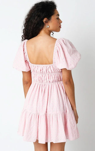 Back view of the Kendall pink eyelet dress featuring a romantic open back and stretchy smocked waist