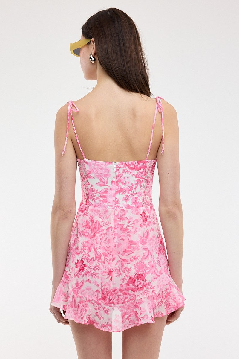 Back view of the pink floral romper dress with a smocked panel and back zipper