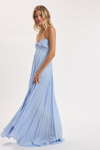 Side profile of strapless light blue pleated maxi dress