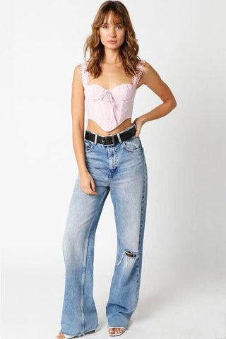 Light pink lace bustier corset top styled with high waisted jeans