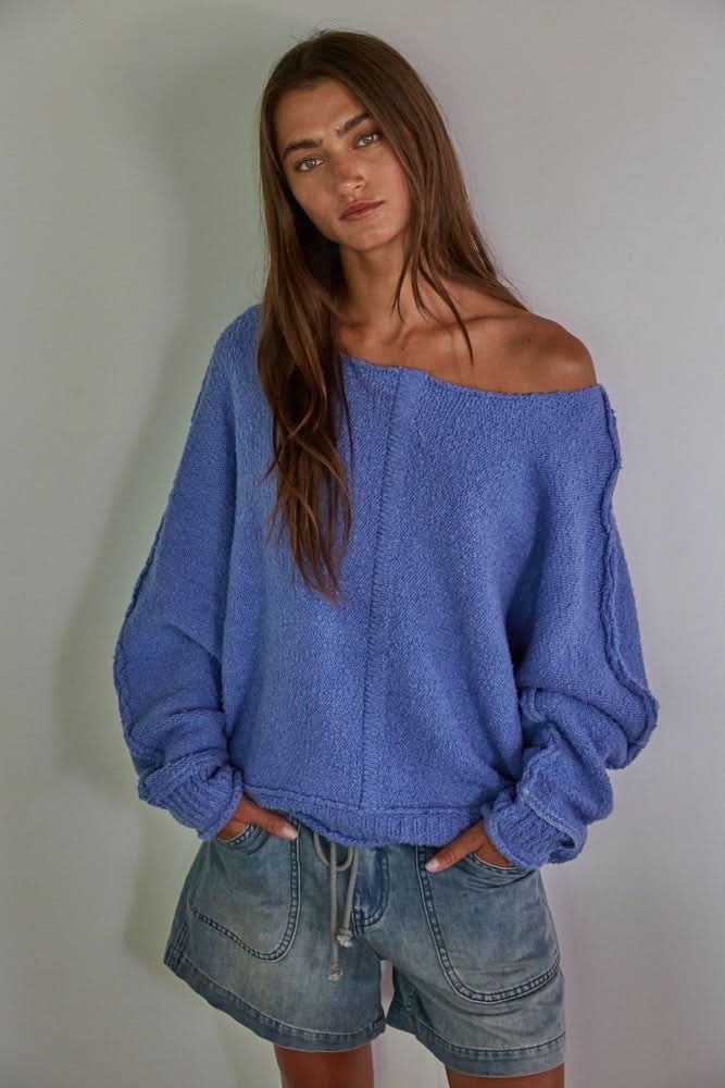 Model wearing the Elara blue boat-neck oversized sweater.