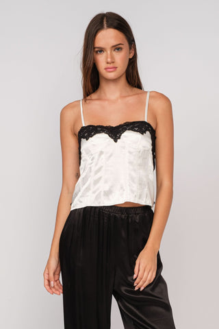 Woman wearing the Lucy ivory satin lace camisole with white lace trim and bustier bodice
