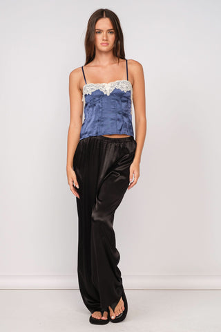 Outfit view of the Lucy navy satin crop top with black satin pants and sandals