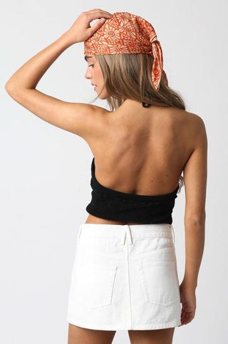 Back view of Monica Off White Denim Mini Skirt styled with a halter top 
