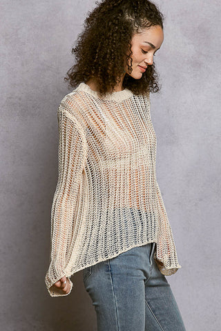 Side view showing the relaxed drape of the Sola natural crochet sweater