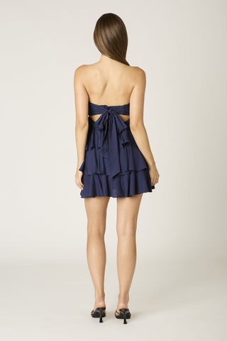 Detailed view of the elastic back and flowing tie on the Charlotte navy dress
