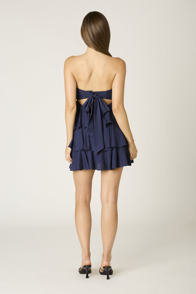 Detailed view of the elastic back and flowing tie on the Charlotte navy dress