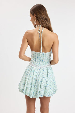 Back view of the Naya blue floral halter dress highlighting the open back and hidden zipper closure