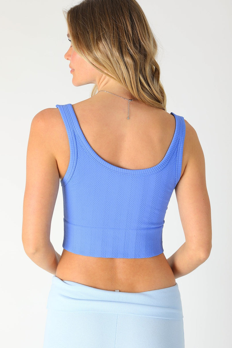 The NIKIBIKI Marina Blue crop top flipped to the scoop neck side showing the reversible design.
