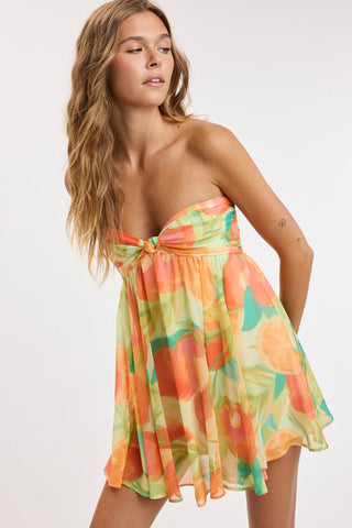 Colette orange tropical print strapless mini dress on model