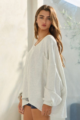 Side view of oversized grey slouchy sweatshirt