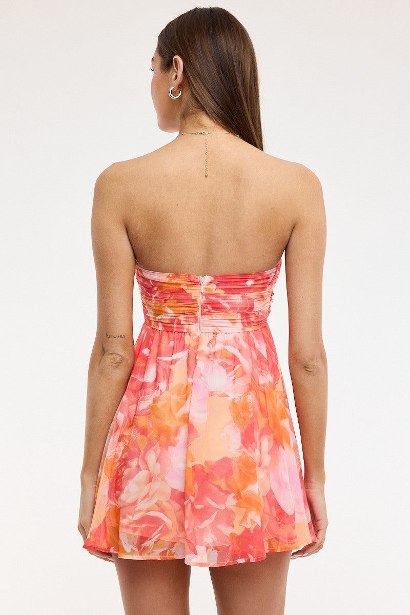 Back view of pink and orange floral babydoll mini dress