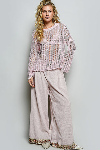 Full body view of the Sola pink sheer sweater styled as a vacation outfit