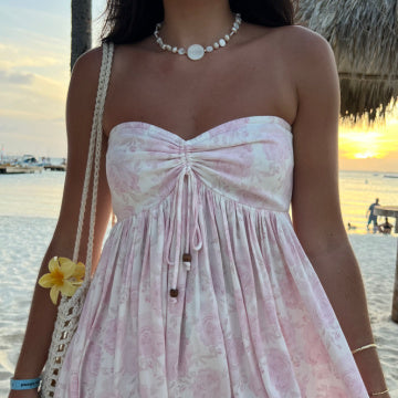 Short pink floral mini dress with a feminine boho print for summer parties