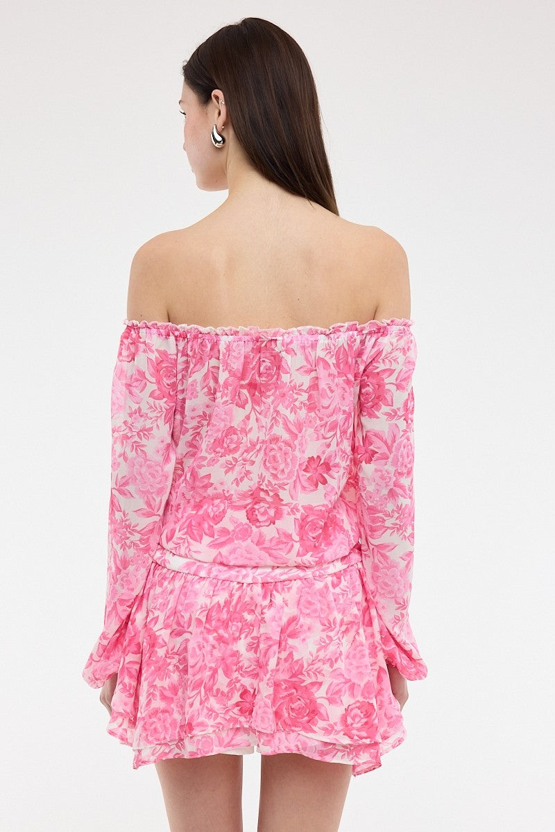 Back view of the Pixie pink floral dress showing the elasticized off-the-shoulder fit